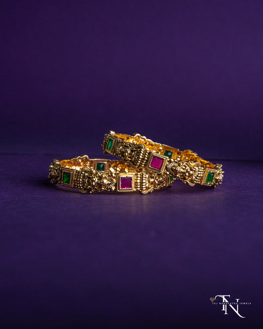 Festive Lakshmidevi Bangles with Rich Red and Green Stone Embellishments